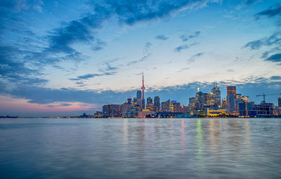 City at waterfront during sunset