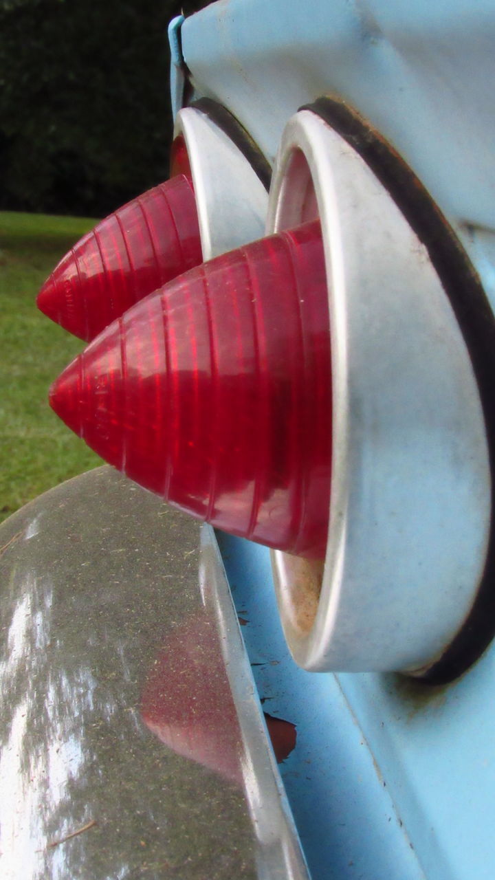 CLOSE-UP OF RED TELEPHONE ON METAL