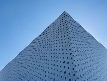 Low angle view of modern building against clear blue sky