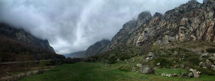 Panoramic view of land and mountains against sky