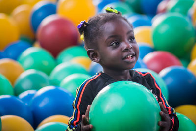 Close-up of cute girl playing with balls