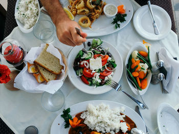 Cropped image of hand taking salad