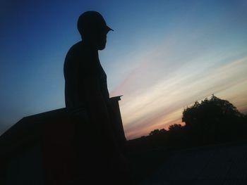 Low angle view of silhouette statue against clear sky