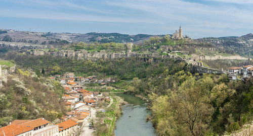 High angle view of townscape by river in city