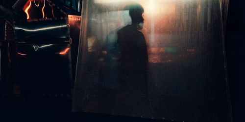 Man standing in illuminated city at night