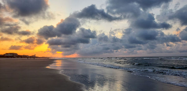 Scenic view of beach against sky during sunset