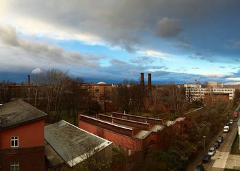 Buildings against cloudy sky