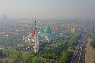 High angle view of road by buildings against sky