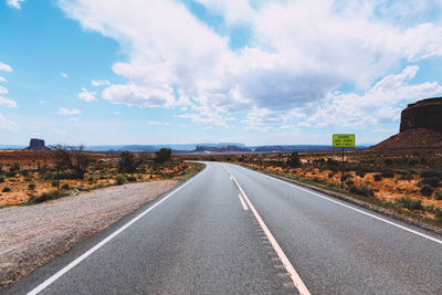 Road by landscape against sky