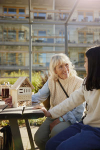 Woman and girl making bug hotels together