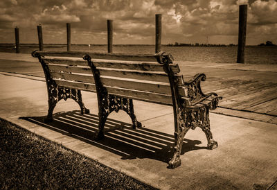 Empty bench against calm sea