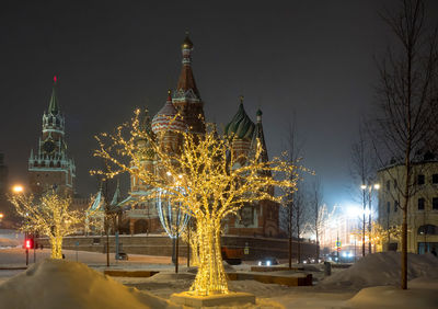 Illuminated christmas tree in city at night