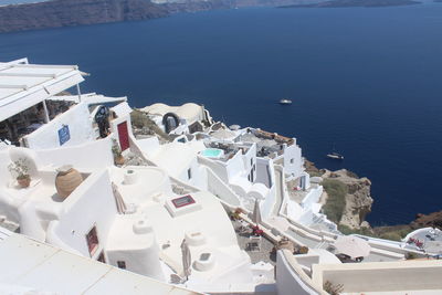 High angle view of buildings by sea in town