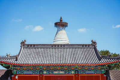 Low angle view of building roof against sky