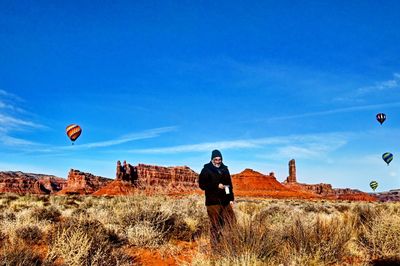 Man standing on field against sky