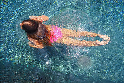 High angle view of girl swimming in pool