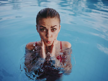 Portrait of young woman swimming in pool