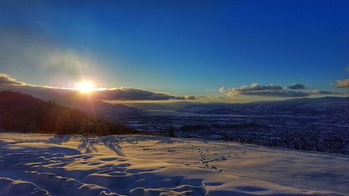 Scenic view of beach against sky during winter