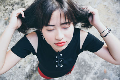 High angle portrait of woman with hands