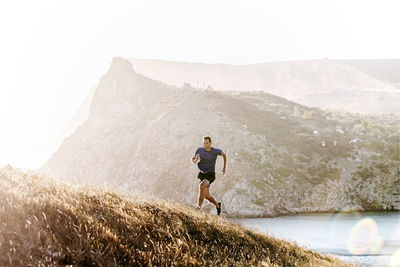 Rear view of man walking on mountain