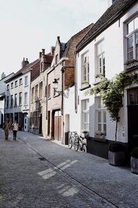 People on street in city against sky