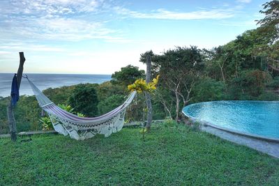 Scenic view of swimming pool by sea against sky