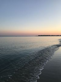 Scenic view of sea against clear sky during sunset