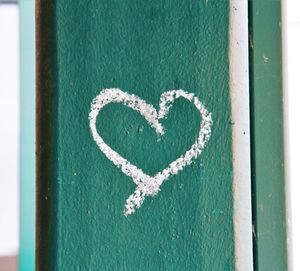 Close-up of heart shape on white wall
