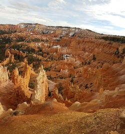 Panoramic view of rocks on landscape against cloudy sky