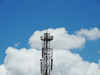 Low angle view of communications tower against sky
