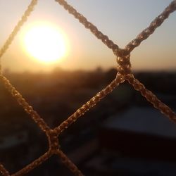 Close-up of ropes against sky during sunset