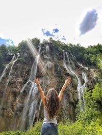 Rear view of woman standing in water