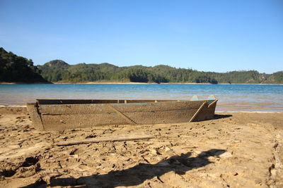 Scenic view of beach against clear blue sky