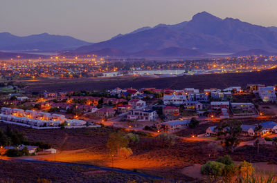 High angle view of illuminated town against sky