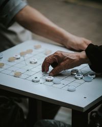 Cropped image of people playing board game