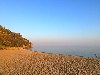 Scenic view of beach against blue sky