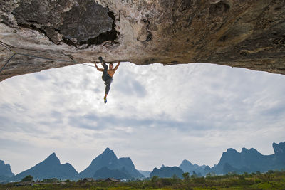 Man climbing steep overhang in yangshuo / china