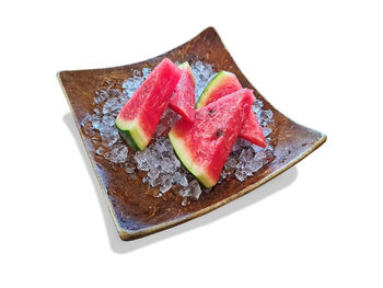 High angle view of cake on plate against white background