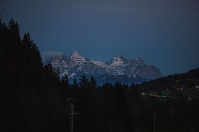 Scenic view of snowcapped mountains against sky during winter