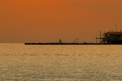 Scenic view of sea against clear sky during sunset