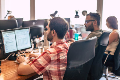 High angle view of people working on computer in office