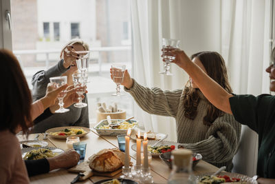 Family raising toast at dinner