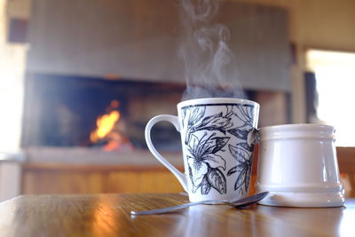 Close-up of coffee cup on table at home