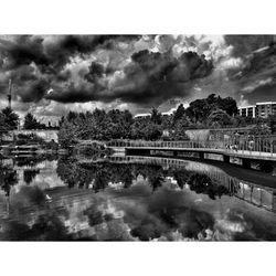 Clouds over river with buildings in background