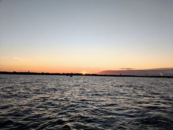 Scenic view of sea against clear sky during sunset