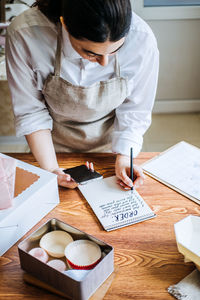 Small local business owner of confectionery, sweet-shop, pastry-shop. asian arabic woman pastry