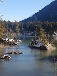 Scenic view of lake against clear sky during winter