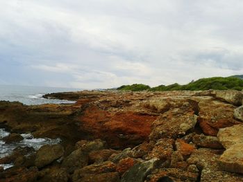 Scenic view of sea against cloudy sky