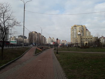 Street amidst buildings in city against sky