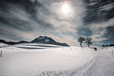 Scenic view of snow covered mountains against sky